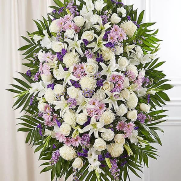 Standing floral spray of white, pink, and purple flowers on an easel