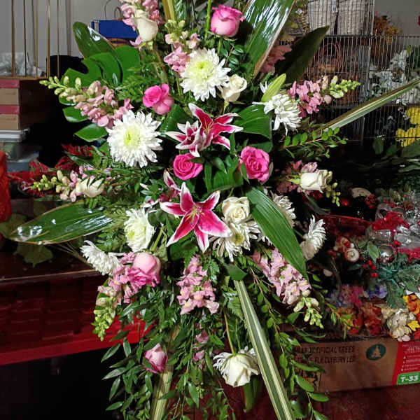 Large standing floral spray with pink and white blooms