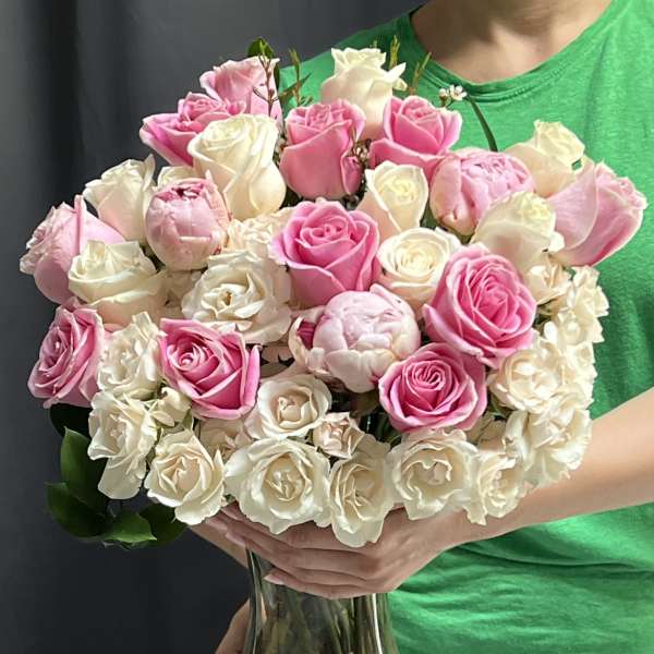 Bouquet of pink and white roses in a clear glass vase