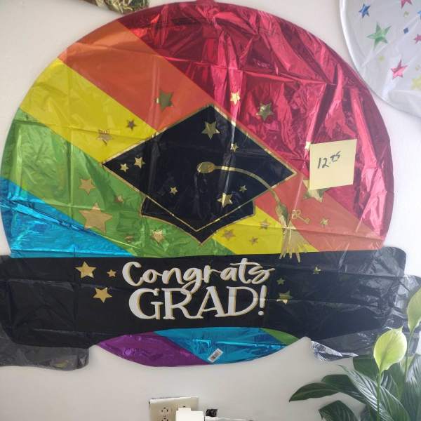 Graduation-themed foil balloon with a cap and "Congrats Grad!" text