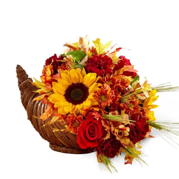 Autumn flower arrangement in a woven cornucopia basket with sunflowers and roses