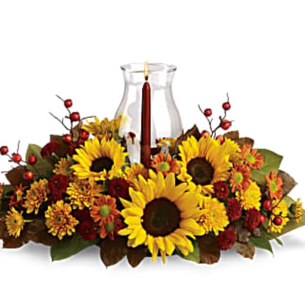 Sunflower centerpiece around a glass hurricane candle holder