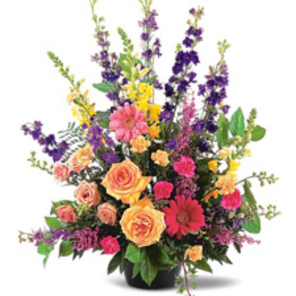 Colorful mixed flower arrangement in a black vase