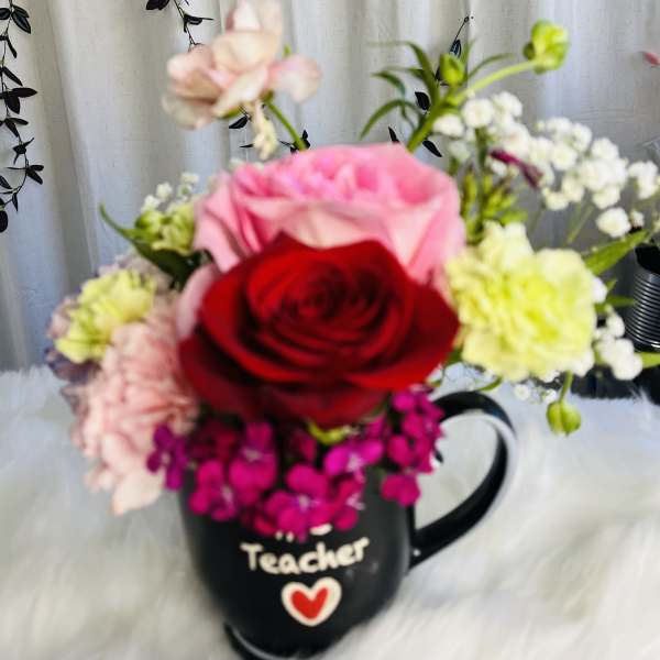 Mixed flower bouquet in a black teacher mug