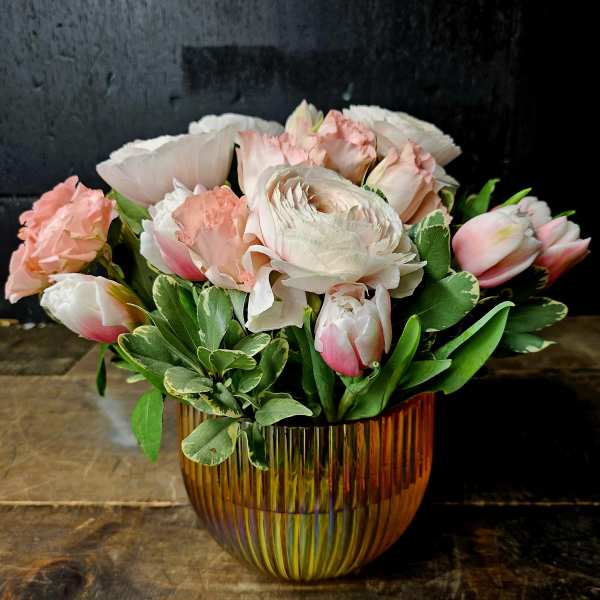Pink and white bouquet in an amber glass vase
