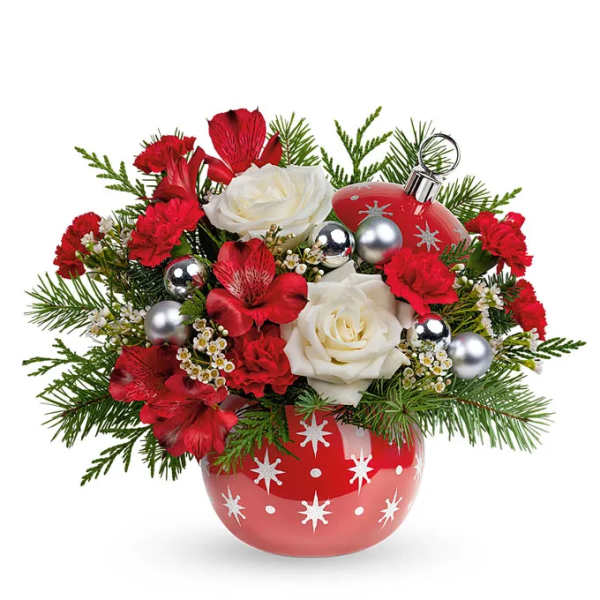 Red and white floral arrangement in a red ornamented vase