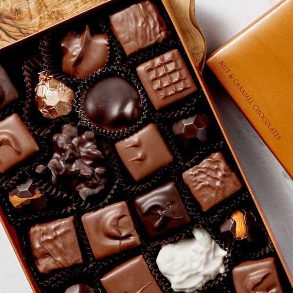 Box of assorted chocolates in black paper cups