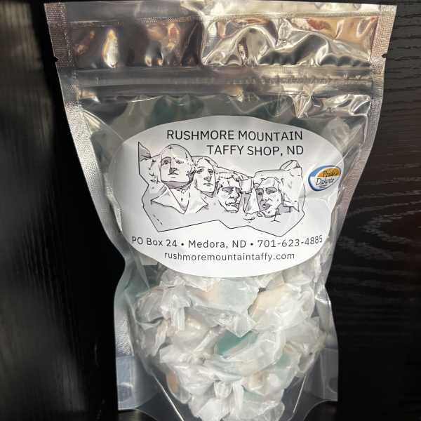 Clear bag of white taffy candy with a Mount Rushmore label