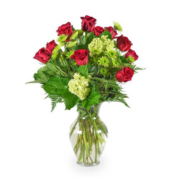 Red roses and green hydrangeas in a clear glass vase