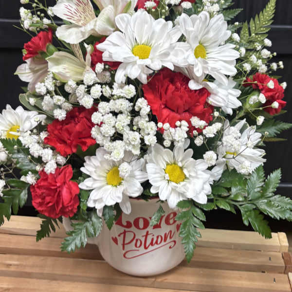 Red and white mixed bouquet in a mug-shaped vase