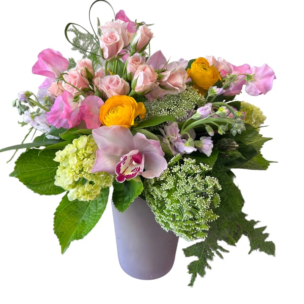 Pink roses and yellow ranunculus in a lavender vase