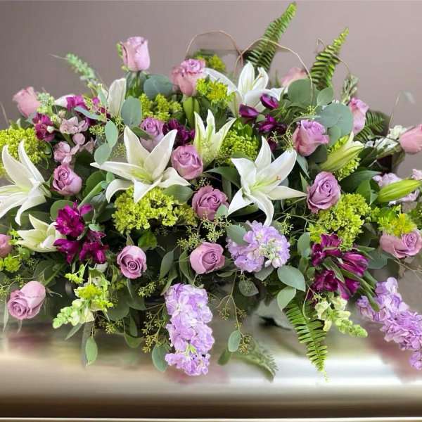 Lavender roses and white lilies in a low floral arrangement