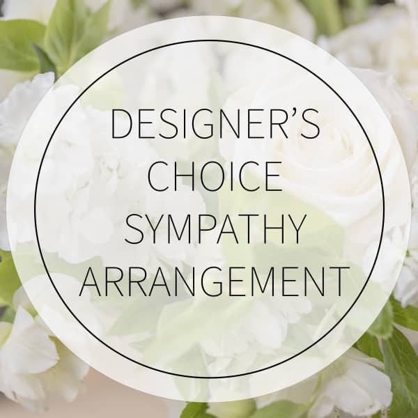White sympathy arrangement with pale green flowers and a circular text overlay