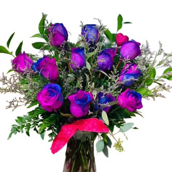 Bouquet of dyed purple and blue roses in a glass vase