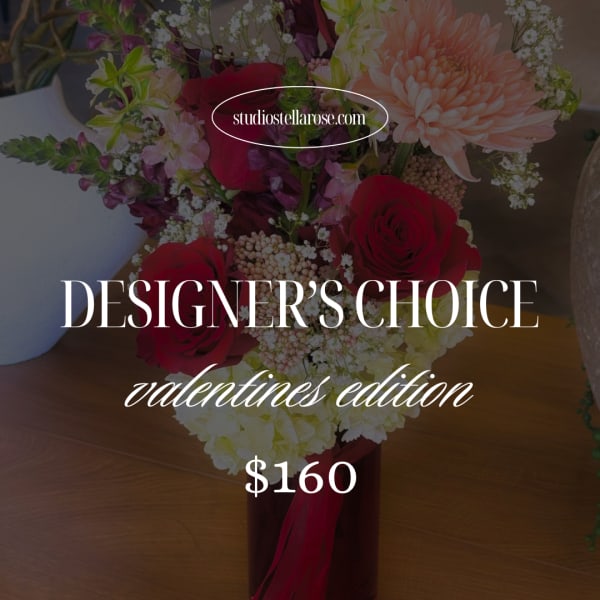 Mixed bouquet of red roses, peach chrysanthemum, and white filler flowers in a vase