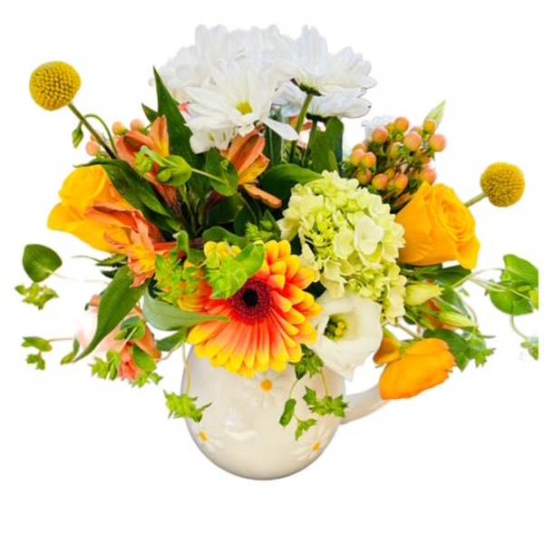 Colorful mixed bouquet in a white ceramic pitcher vase