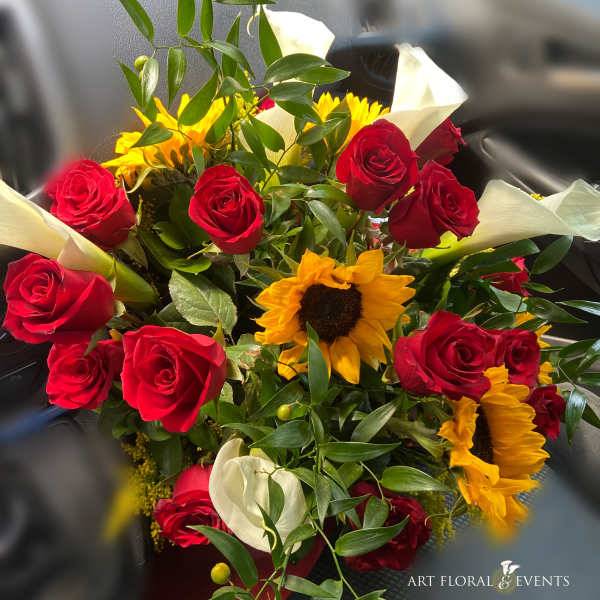 Bouquet of red roses, sunflowers, and white calla lilies