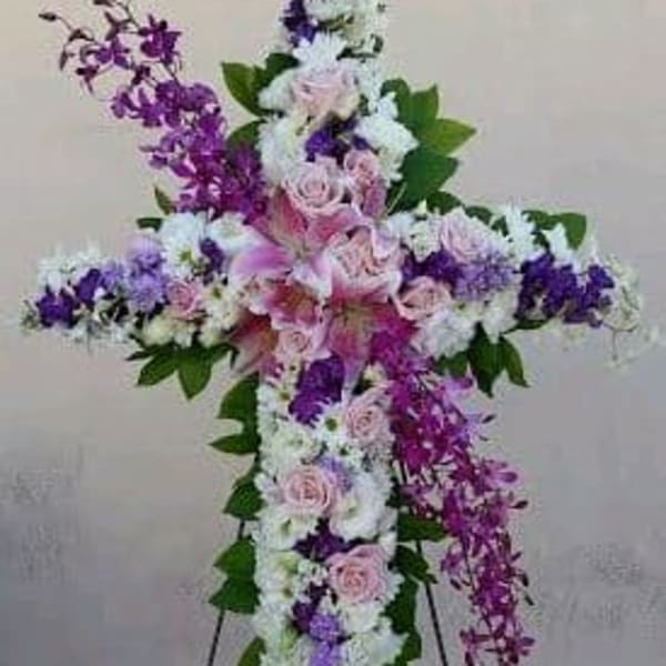 Cross-shaped floral standing spray with pink, white, and purple flowers