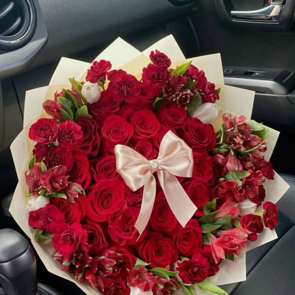 Large bouquet of red roses and red alstroemeria with a satin bow