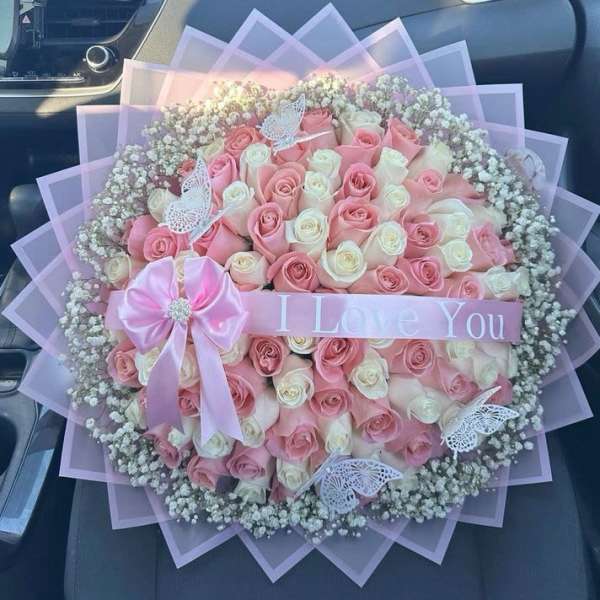 Pink and white rose bouquet with a "I Love You" ribbon