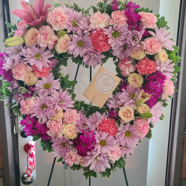 Heart-shaped floral wreath with pink and lavender flowers