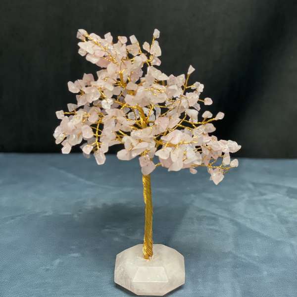 Small crystal tree with pale pink stones on a white base