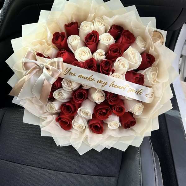 Bouquet of red and white roses with a satin ribbon