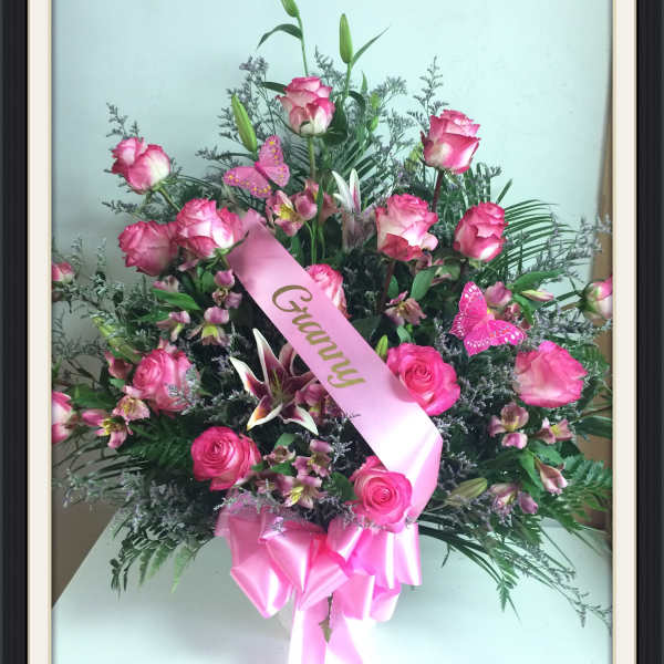 Pink rose bouquet with lilies and a pink ribbon
