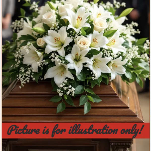 White lilies and roses arranged on a casket