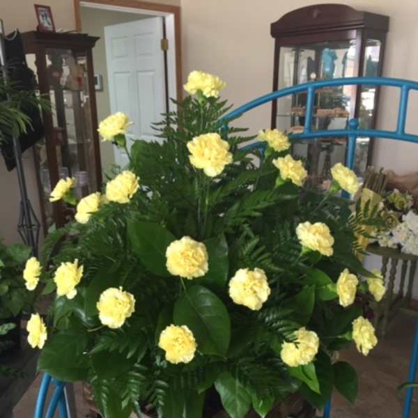 Yellow carnations in a wooden crate arrangement