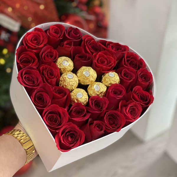 Heart-shaped box of red roses with gold-wrapped chocolates