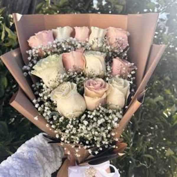 Bouquet of pale pink and white roses with baby's breath