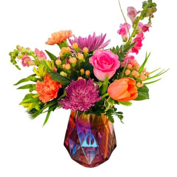 Colorful mixed flower arrangement in a faceted iridescent vase