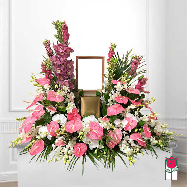 Large floral arrangement with pink anthuriums, white orchids, and purple orchids