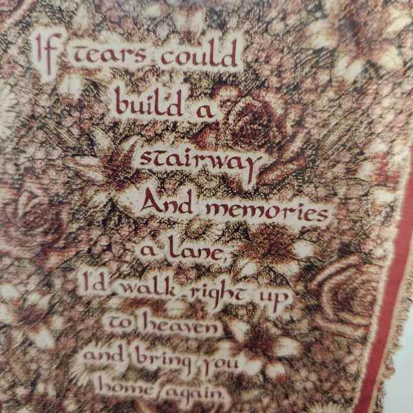 Decorative wall hanging with floral pattern and a memorial quote
