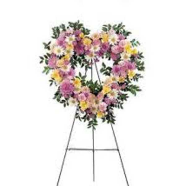 Heart-shaped floral wreath on a metal easel