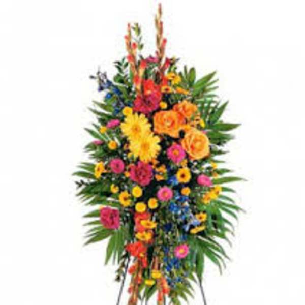 Tall standing floral spray with bright mixed flowers on an easel