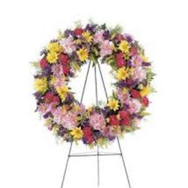 Large multicolored floral wreath on a metal stand