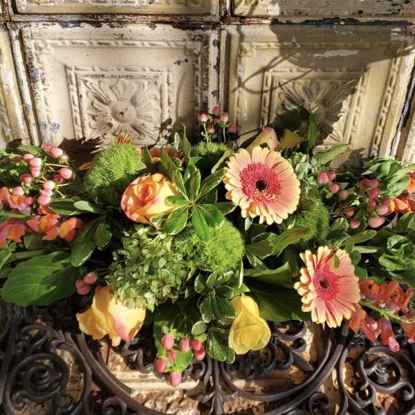 Mixed floral arrangement with pink gerbera daisies and yellow roses