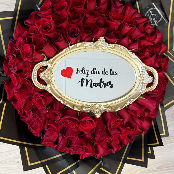 Round bouquet of red roses with a gold-framed Mother's Day sign