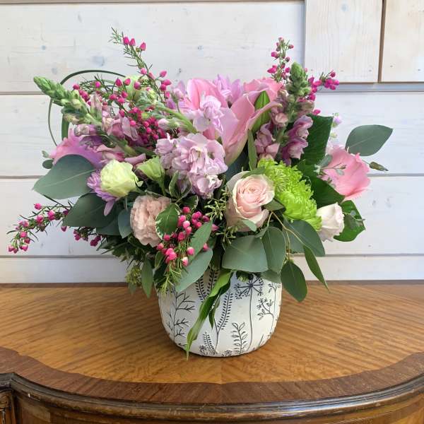Pink and green mixed bouquet in a patterned ceramic vase