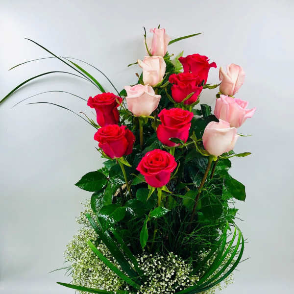 Basket arrangement of red and pale pink roses with baby's breath