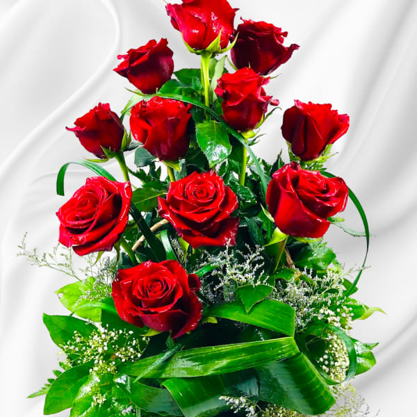 Tall basket arrangement of red roses with greenery
