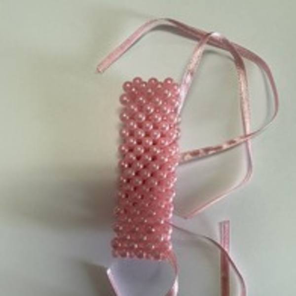 Pink beaded ribbon corsage with satin ties