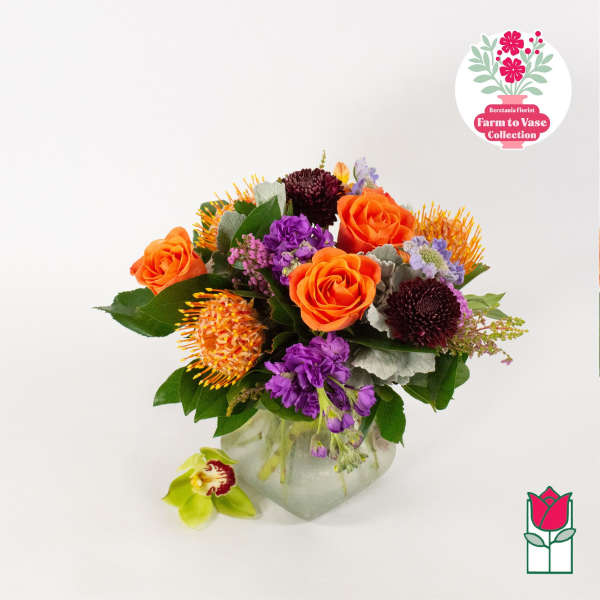 Bouquet of orange and purple flowers in a glass vase