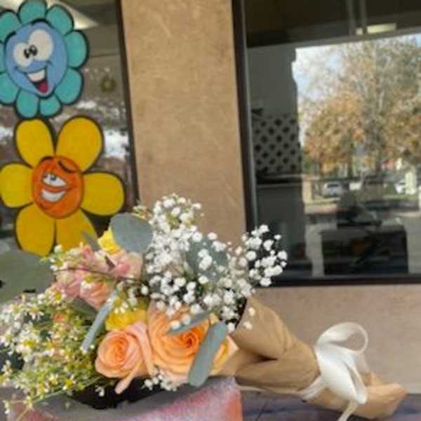 Bouquet of peach roses and white baby's breath with ribbon