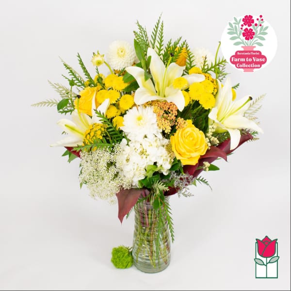 Yellow and white mixed bouquet in a clear glass vase