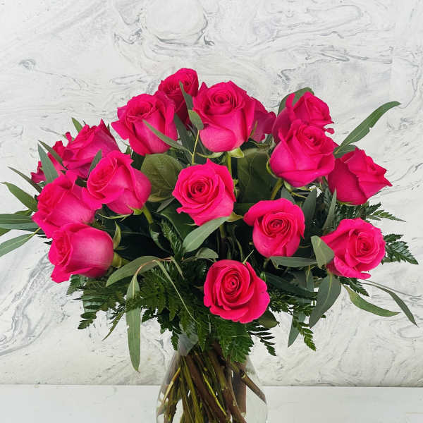 Bouquet of bright pink roses in a clear glass vase