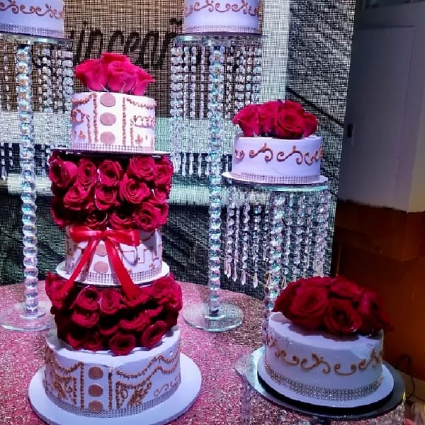 Tiered cake stands decorated with red roses and rhinestone trim