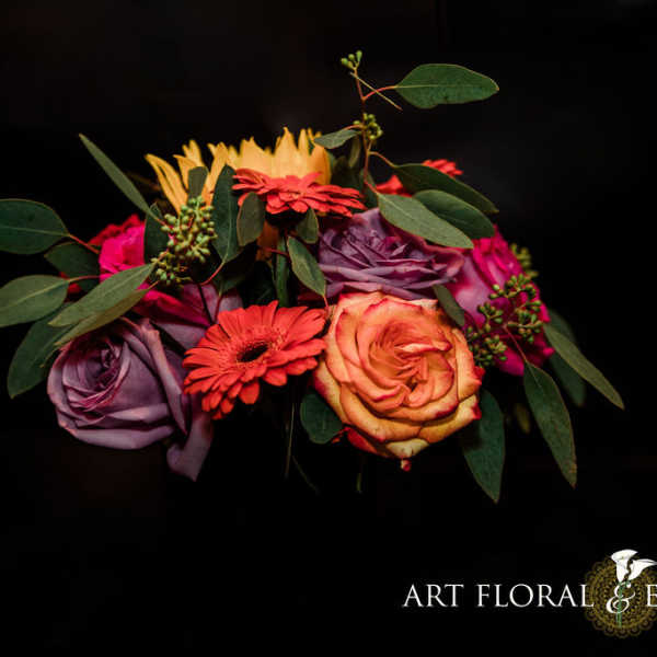 Colorful bouquet of roses and gerbera daisies with greenery